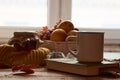 Autumn leaves, cup of coffee, warm scarf, fruits basket and book Royalty Free Stock Photo