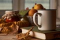 Autumn leaves, cup of coffee, warm scarf, fruits basket and book Royalty Free Stock Photo