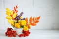 Autumn leaves and flowers on a wooden table. Autumn background with copy space. Autumn still life.