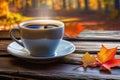 Autumn leaves and a hot steaming cup of coffee. Wooden table and cup of coffee on autumn background. Autumn season, free Royalty Free Stock Photo