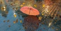 Autumn leaves pink umbrella on old pavement  rainy evening city light    blurring bokeh effect background Royalty Free Stock Photo