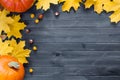 Autumn leaves and pumpkin over old dark wooden background with copy space Royalty Free Stock Photo