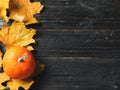 Autumn leaves and pumpkin over old wooden background Royalty Free Stock Photo