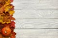 Autumn leaves and pumpkin over old wooden background Royalty Free Stock Photo