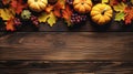 Autumn leaves, pumpkins and grapes as a border on rustic wooden table, top view, Thanksgiving and Halloween autumn background with Royalty Free Stock Photo