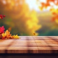 Autumn Leaves Resting on a Wooden Table Against a Blurred Forest Background Royalty Free Stock Photo