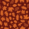 Autumn leaves seamless vector background. Orange leaf silhouettes on a red background. Acorns, oak tree, maple tree pattern. Royalty Free Stock Photo