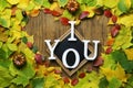 Autumn leaves in shape of heart on wooden table