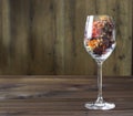 Autumn leaves in a wine glass on wooden table background Royalty Free Stock Photo