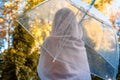 Autumn. Lonely muslim woman in a headscarf under a transparent umbrella with rain drops walking in a park, garden. Rainy day lands Royalty Free Stock Photo