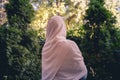 Autumn. Lonely muslim woman in a headscarf walking in a park, garden. Vintage Toned.