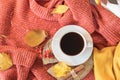 Autumn look: a warm cosy red sweater and a cup of warming coffee.