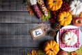 Autumn maple leaves with Pumpkin, apple, corn and red berries on old wooden background. Thanksgiving day concept Royalty Free Stock Photo