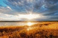 Autumn meadows lush grass and lakeside with the rays of the sun silence Royalty Free Stock Photo