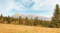 Autumn meadows near country road, panorama of Tatry mountains with Krivan peak Slovak symbol as seen from Vazec village, in Royalty Free Stock Photo