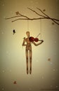 Autumn melancholy, last autumn melody, marionette hanging on the tree branch and playing violine for tit birds,