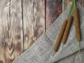 Autumn minimalist concept with bulrush with sack fabric on wooden background. Royalty Free Stock Photo