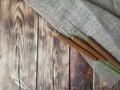 Autumn minimalist design with reeds, cattail and sack fabric on wooden background.