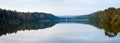 Autumn misty evening lake panorama.