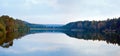 Autumn misty evening lake panorama with grove on shore