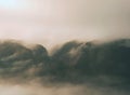 Autumn misty landscape. High trees and hill peaks in mist