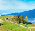 Autumn misty morning plateau with stack of hay and country dirty road (Carpathian Mountains, Ukraine Royalty Free Stock Photo