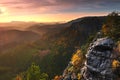 Autumn misty valley full of morning mist view through branches. Foggy and misty daybreak on the sandstone view point Royalty Free Stock Photo