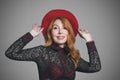 Autumn mood of beauty: smiling woman with red hat, studio portrait Royalty Free Stock Photo