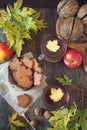 Autumn mood: cinnamon cookies in form of maple leaves, two cups of tea, red apples and yellow leaves Royalty Free Stock Photo