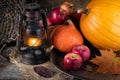 Harvest stillife pimpkin, apples, gas lantern, yellow maple leaf.