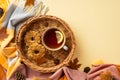 Autumn mood concept. Top view photo of wicker basket cup of tea with lemon slice cookies anise yellow maple leaves pine cones and Royalty Free Stock Photo