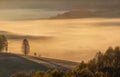 Autumn. Dawn light illuminates the misty valley