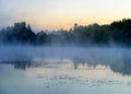 autumn morning by the lake, fog over the surface of the water, a moment before sunrise Royalty Free Stock Photo