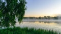 autumn morning by the lake, fog over the surface of the water, a moment before sunrise Royalty Free Stock Photo