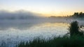 autumn morning by the lake, fog over the surface of the water, a moment before sunrise Royalty Free Stock Photo