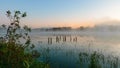 autumn morning by the lake, fog over the surface of the water, a moment before sunrise Royalty Free Stock Photo