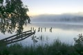 autumn morning by the lake, fog over the surface of the water, a moment before sunrise Royalty Free Stock Photo