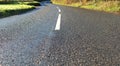 Wet country road in sunshine. Sunny November in the South West of the UK Royalty Free Stock Photo