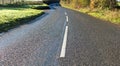 Wet country road in sunshine. Sunny November in the South West of the UK Royalty Free Stock Photo