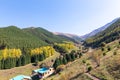 Autumn mountain landscape. House in the mountains. green and yellow trees on the hillside. Forest in the mountains. Kyrgyzstan Royalty Free Stock Photo