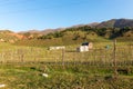 Autumn mountain landscape. House in the mountains. green and yellow trees on the hillside. Forest in the mountains. Kyrgyzstan Royalty Free Stock Photo