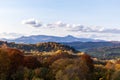 Autumn mountain landscape - yellowed and reddened autumn trees combined with green needles and blue skies. Royalty Free Stock Photo