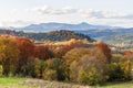 Autumn mountain landscape - yellowed and reddened autumn trees combined with green needles and blue skies. Royalty Free Stock Photo