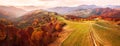 Autumn mountain panorama. Dirt road on top of the hills