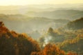 Autumn mountain in the sunset mist. Lens flare effect. Royalty Free Stock Photo