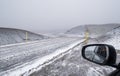 Autumn mountain views along the Kjolur Highland Road F35, Iceland, Europe. Autumn snowstorm beginning. View in car mirror