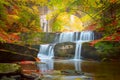 Autumn natural landscape - river waterfall in colorful autumn forest with old bridge Royalty Free Stock Photo