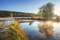 Autumn nature. Fall landscape. Calm scene on river side in misty morning at sunrise. Beautiful october foggy morning. Trees on Royalty Free Stock Photo