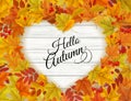 Autumn nature frame with colorful autumn leaves a heart shape on a wooden sign. Royalty Free Stock Photo