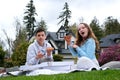 Autumn nature. Fun and liesure. Young teenage couple picnic on sunflower field in sunset eating pizza Royalty Free Stock Photo